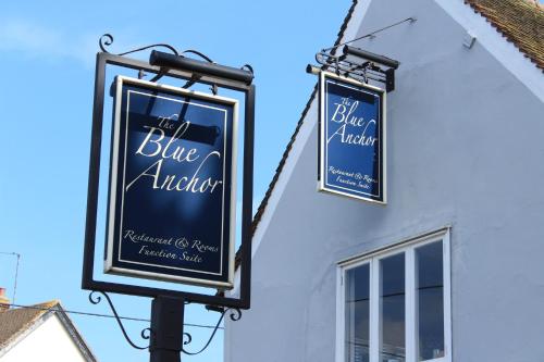 two signs on the side of a building at The Blue Anchor in Feering