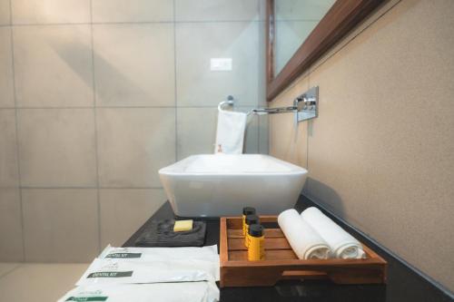 a bathroom with a white sink on a counter at RajBagh by Aaryam in Sawāi Mādhopur