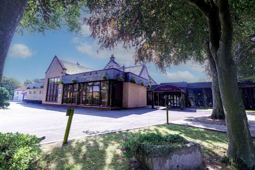 a building with a tree in front of it at Pitbauchlie House Hotel - Sure Hotel Collection by Best Western in Dunfermline