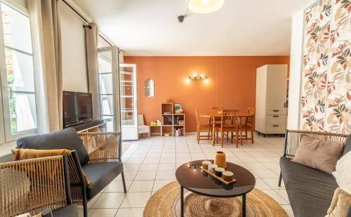 a living room with a couch and a table at Gîte des pins in Sainte-Marie-de-Ré