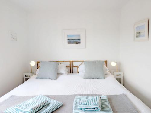 a bedroom with a bed with two towels on it at Sanderling House, with parking - walk to beach in Earnley
