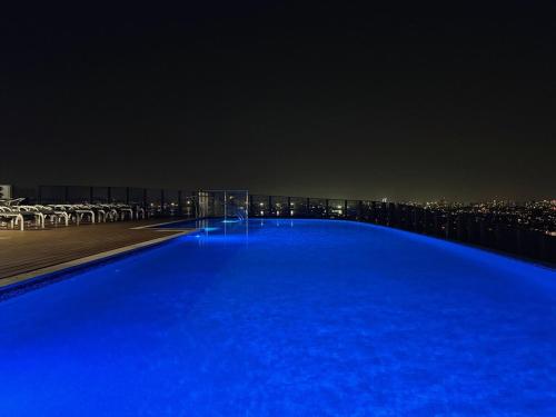 a large blue pool on top of a building at night at RiverView Breeze Hamilton 3B2B with Free Parking in Brisbane