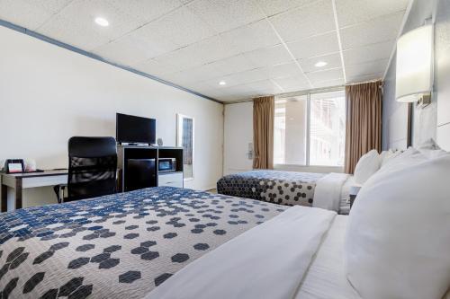 a hotel room with two beds and a desk at Edyn Hotel By Townhouse Wytheville US 52 in Wytheville
