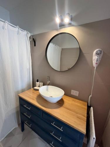 a bathroom with a sink and a mirror at Andina Apart - Calm in the heart of Mendoza in Mendoza