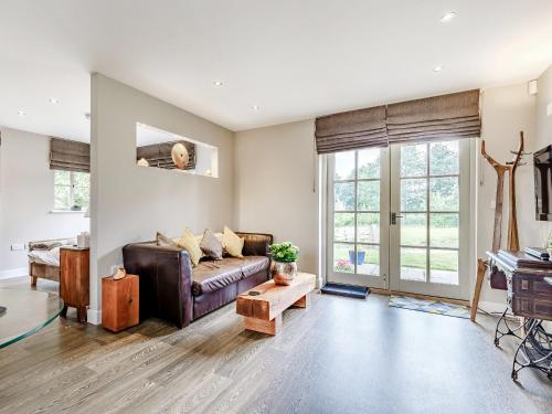 a living room with a couch and a table at Little Barn in Shirland