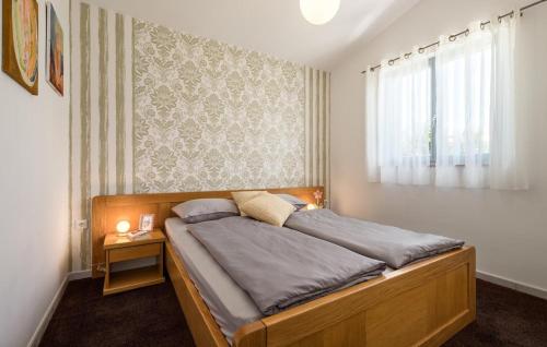 a bedroom with a wooden bed with a window at Villa Mir - Rovinj by Villas Guide in Štanga