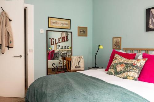 a bedroom with a bed with pink and green at Fernshade Cottage By Birch Stays in Stonehaven