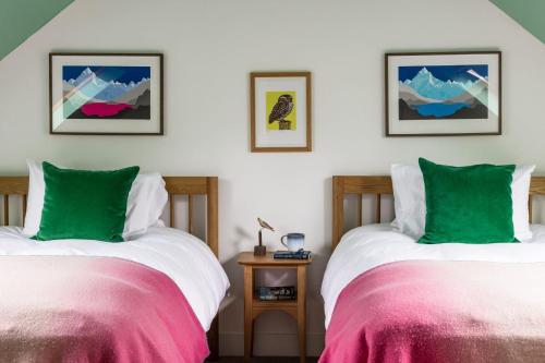 two beds sitting next to each other in a room at Fernshade Cottage By Birch Stays in Stonehaven