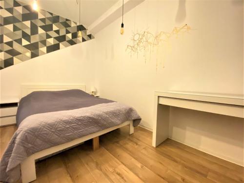 a bedroom with a bed and a fireplace at Apartament nad Kwisą Mountain Aparts in Świeradów-Zdrój