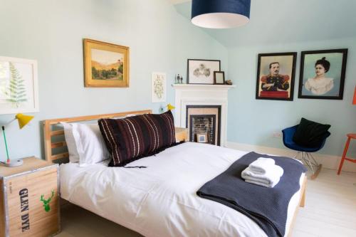 a bedroom with a bed with a blanket on it at Glen Lodge And Abhainn Cottage By Birch Stays in Stonehaven