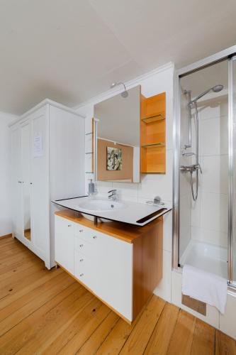 a bathroom with a sink and a shower at Gasthaus Moosegg in Lochau