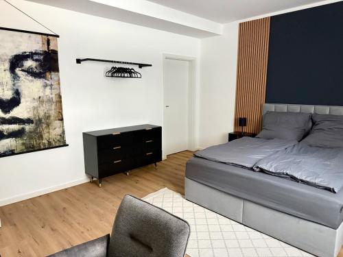 a bedroom with a bed and a desk and a chair at Modern Holiday Apartment in Osnabrück 13001 in Osnabrück
