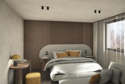a bedroom with a large bed and a window at Hotel Hell in Ortisei