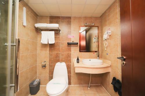 a bathroom with a toilet and a sink at Chaogu Hotel in Changchun