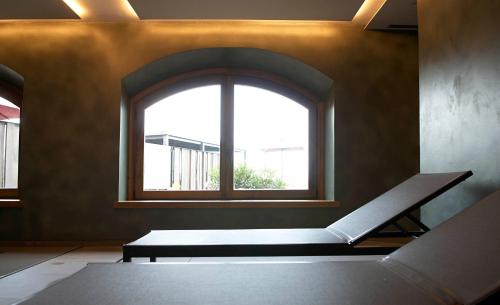 a room with a window and a bench in front of it at Hotel Boutique Puig Francó - Adults Only in Camprodon