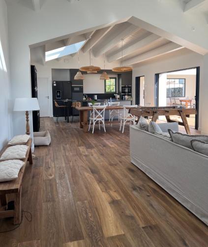 a living room with a couch and a table at La Parenthèse in L'Ile d'Yeu