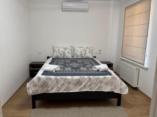a bedroom with a bed with two towels on it at Casa Veche 