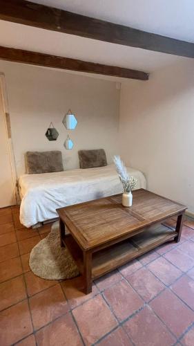 a bedroom with a bed and a coffee table at Maison de charme La rochelle - Île de Ré in La Rochelle