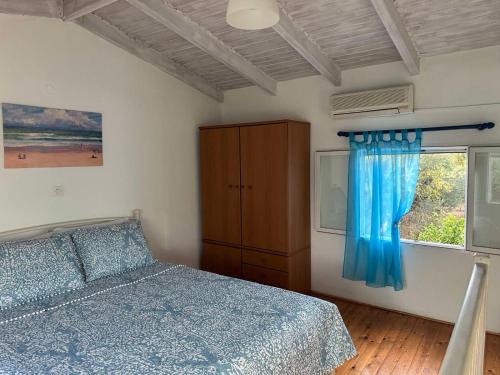 a bedroom with a bed and a window at Ostria spiti in Aígio
