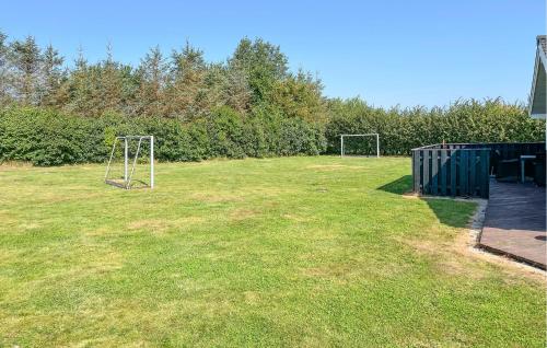 a field with two soccer goals in the grass at Lovely Home In Hadsund With Sauna in Haslevgårde