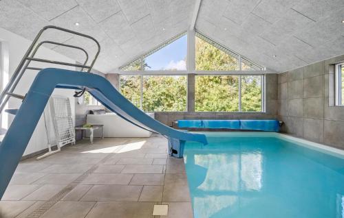 an indoor swimming pool with a slide in a house at Lovely Home In Gørlev With Sauna in Reersø