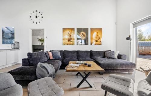 a living room with a couch and a table at Lovely Home In Gørlev With Sauna in Reersø
