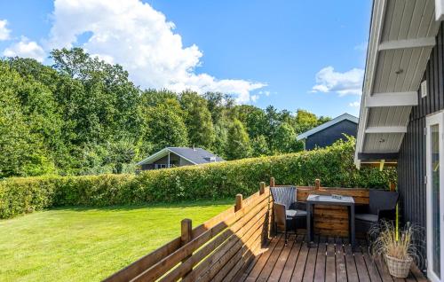 a patio with a table and chairs on a wooden deck at 2 Bedroom Beautiful Home In Egernsund in Egernsund