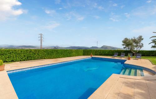a large swimming pool with blue water at S'ametllerar in Artá