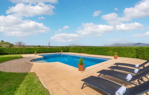 a swimming pool with two lounge chairs next to it at S'ametllerar in Artá