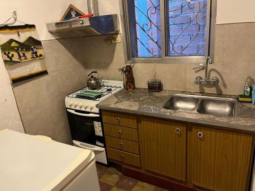 a small kitchen with a sink and a stove at Tu casa1 - Frente in General Pacheco