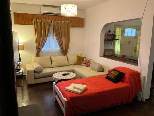 a living room with a couch and a mirror at Tu casa1 - Frente in General Pacheco