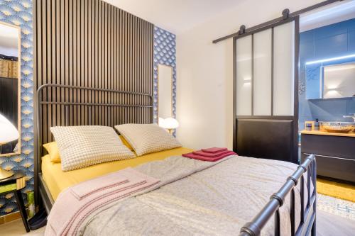 a bedroom with a bed with two pillows at PARIS-JulesVERNE-Bienvenue-Terrasse-Netflix in Pantin