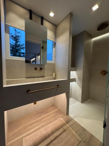 a bathroom with a mirror and a shower at eleni's villa in Kandhíla