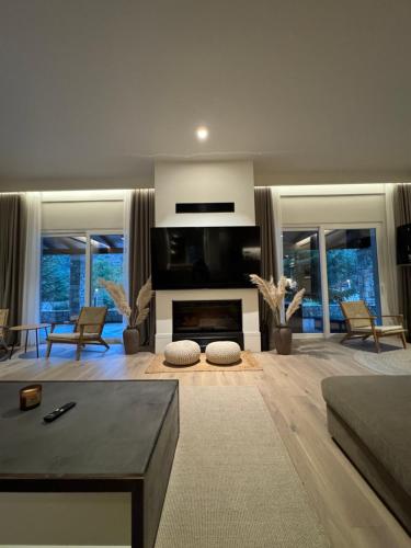 a living room with a couch and a fireplace at eleni's villa in Kandhíla
