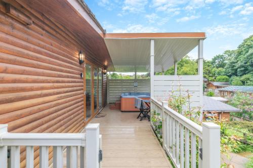 a house with a wooden fence and a deck at Landal Leycroft Valley in Perranzabuloe