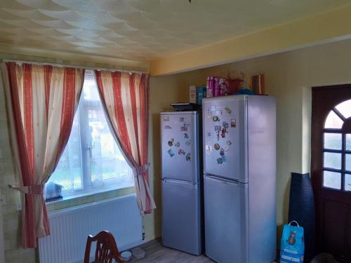 a kitchen with a refrigerator and a window at Комната in Wakefield