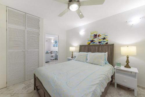 a bedroom with a bed and a ceiling fan at Rum Runner - Golden View 328 in Saint James