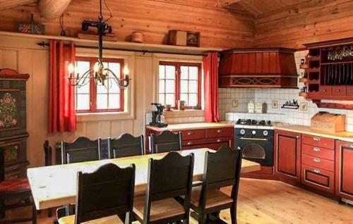 a kitchen with a table and chairs in a room at Stunning Home In Oppdal With Sauna in Fagerhaug