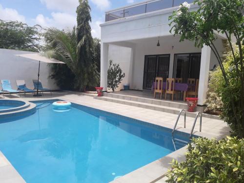 a swimming pool in front of a house at Chez Philo et Marc in Somone