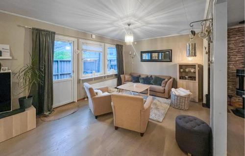 a living room with a couch and a table at Cozy Home In Flekkefjord With House Sea View in Flekkefjord
