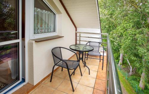 two chairs and a table on the balcony of a house at Lovely Apartment In Jastrzebia Gora With Sauna in Tupadły