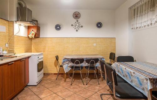 a kitchen with a table and chairs in a kitchen at Lovely Apartment In Jastrzebia Gora With Sauna in Tupadły