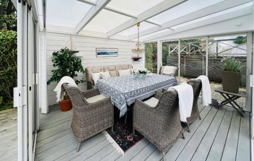 a patio with a table and chairs on a deck at 3 Bedroom Stunning Home In Grebbestad in Grebbestad