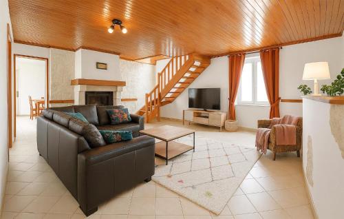 a living room with a couch and a television at Three Bedroom Lovely Home In Joganville in Joganville