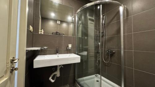 a bathroom with a sink and a shower at Colibring nomads in Tbilisi City