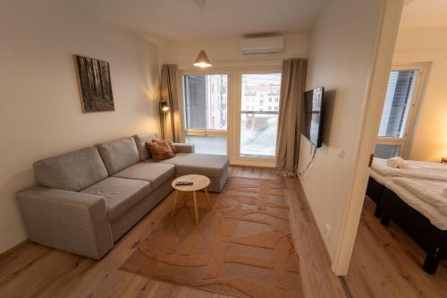 a living room with a couch and a bed at Snowflake X in Rovaniemi