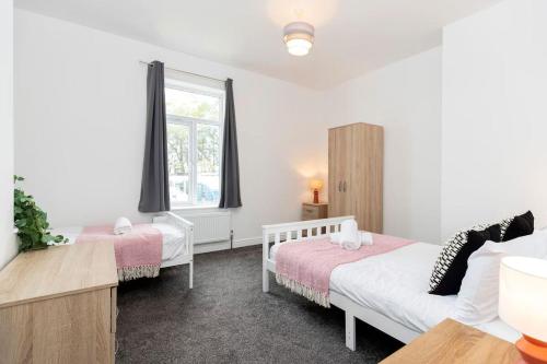 a bedroom with two beds and a window at 2-Bed House•Free Parking•WiFi•Long Stays Welcome in Ferryhill