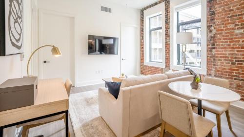 a living room with a couch and a table at Landing Apartments - Birmingham in Birmingham