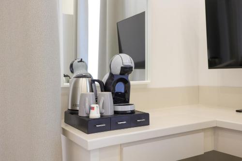 a coffee maker on a counter in a hotel room at Elysium Relais in Naples