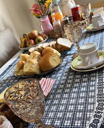 a table with plates of food and glasses on it at Posada Dale Dale in São Gabriel